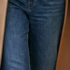 Detail of the straight-leg jeans in the look.